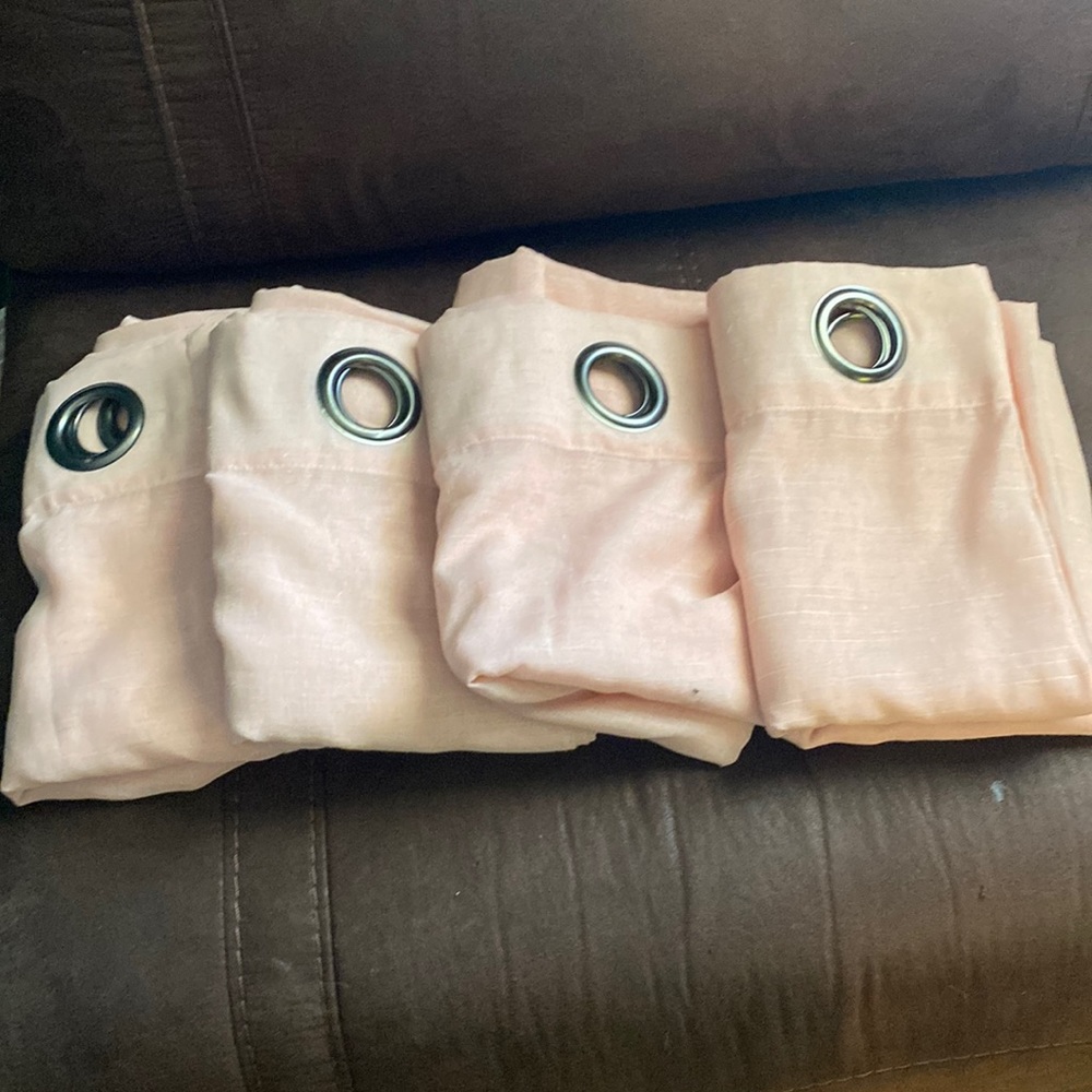 Sheer pink grommet curtain.